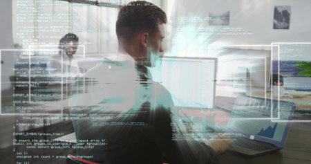 Typing developer wearing dark T-shirt writing code on laptop at wooden desk, with external monitor. Technology, collaboration, workspace, modern, innovation, digital, productivityの写真素材