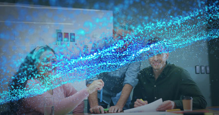 Overlaying digital effects, woman in pink sweater and colleagues examining blue test tube in office. Collaboration, innovation, teamwork, modernoffice, laboratory, digitaleffects, brainstormingの写真素材