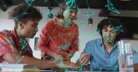 Leaning coworkers marking printed documents on desk in office, colored markers and network overlay. Collaboration, innovation, teamwork, brainstorming, moderndesign, digitalconnection, creativeprocessの写真素材