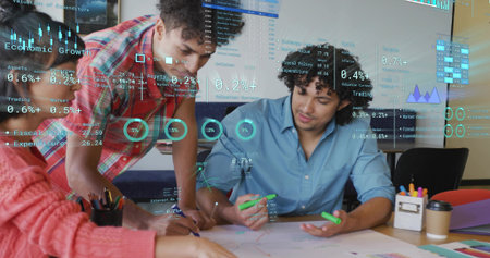 Collaborating colleagues highlighting diagrams with highlighter at office desk, with digital data. Teamwork, brainstorming, innovation, analytics, strategy, creativity, modernの写真素材