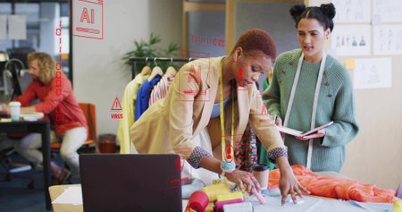 Collaborating two fashion designers examining fabric in fashion design studio with thread spools. Creativity, teamwork, apparel, crafts, artistic, inspiration, bespokeの写真素材