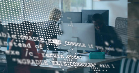 Typing and note taking software team collaborating in open office with code reflections on monitors. Collaboration, technology, modern, productivity, startup, teamwork, innovationの写真素材