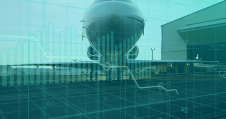 Showing airliner on airport ramp beside maintenance hangar, with baggage carts and digital overlay. Aviation, technology, industrial, engineering, logistics, enterprise, transportationの写真素材