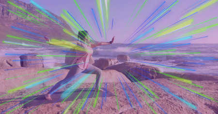 Practicing yogi wearing sweatshirt, leggings in lunge pose on rocky coast with yoga mat, copy space....
