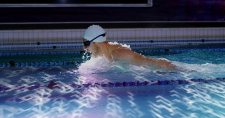 Cutting competitive swimmer stroking in tiled lap pool, with white cap, goggles and lane ropes. Athlete, endurance, aquatic, motion, training, sport, dynamicの写真素材