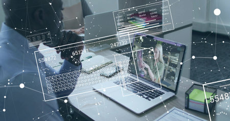 Displaying presenter on laptop while colleague analyzing data in office, with overlays. Collaboration, technology, data visualization, remote work, professional, analysis, communicationの写真素材