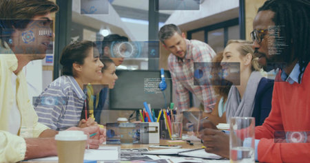 Collaborating team reviewing printed sketches on laptops in conference room, with data overlays. Teamwork, innovation, brainstorming, professionalism, modernity, productivity, communicationの写真素材