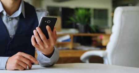 Holding smartphone and pointing finger at tabletop in office, showing file organizer, copy space. Professional, executive, workspace, communication, productivity, minimalistic, corporateの写真素材
