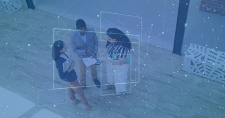 Professionals wearing blazers reviewing printed documents and digital tablet in office data theme. Collaboration, teamwork, modernoffice, dataanalysis, technology, corporate, professionalの写真素材