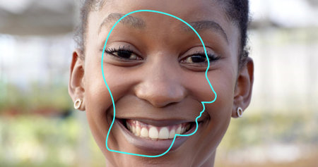 Smiling woman with pulled back hair wearing hoop earrings in greenhouse, with teal doodle outline. Portrait, wellness, artistic, vibrant, nature, joyful, modernの写真素材