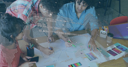 Leaning colleagues sketching design ideas at creative studio table, with smartphone and markers. Innovation, teamwork, brainstorming, collaboration, creative, professional, modernの写真素材