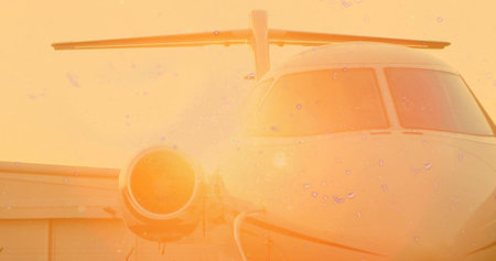 Sitting private jet receiving sunset glow on tarmac with engine intake, cockpit windows, hangar....
