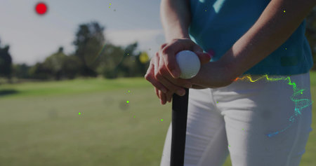 Gripping golfer in turquoise polo shirt, white trousers on fairway, golf club and ball, copy space. Athletic, leisure, professional, outdoor, vibrant, performance, eleganceの写真素材