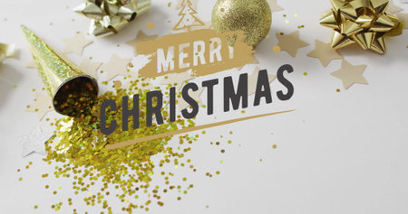Image of merry christmas text over christmas decorations on white background. Christmas, tradition and celebration concept digitally generated image.の写真素材