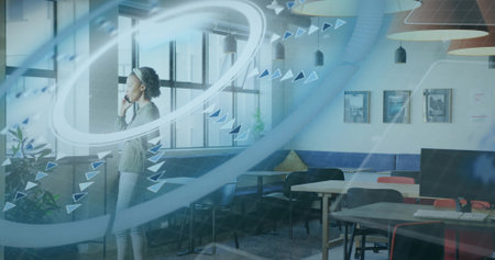 Mid adult businesswoman holding smartphone and signaling data flow in open-plan office, copy space....
