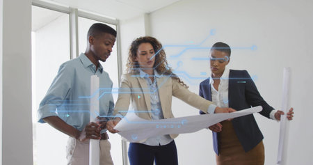 Examining team wearing blazers reviewing blueprint in office, with rolled plans tech overlay. Collaboration, innovation, technology, architecture, teamwork, modern, professionalsの写真素材