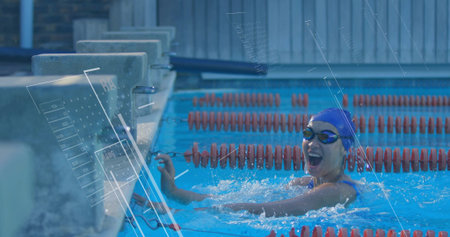 Reaching wall swimmer wearing swimsuit, cap and goggles at pool, with lane dividers, copy space....