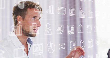 Presenting man interacting with floating data charts in office, finance icons, copy space....