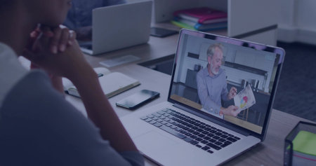 Leaning forward woman clasping hands under chin at office desk with laptop chart, copy space. Collaboration, teamwork, communication, productivity, digital, professional, modernの写真素材