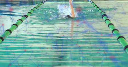 Swimming solo swimmer performing laps at lap pool, with swim cap, goggles, swimsuit and lane ropes. Aquatic, sport, fitness, endurance, sleek, dynamic, reflectionの写真素材