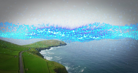 Winding narrow paved road hugging grassy cliffside at cliff edge, with blue light band, copy space....