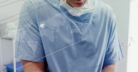Adjusting equipment in clinic, clinician in light blue scrubs with surgical mask and chart overlay....