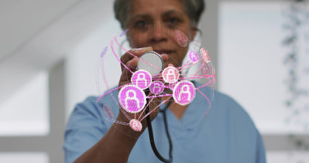 Doctor in scrubs holding stethoscope in hospital room, with holographic user profile padlock icons....