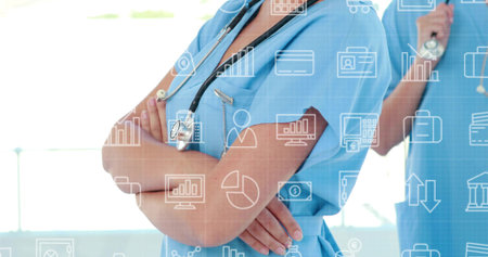 Standing female medics in scrubs with stethoscopes crossing arms in clinic hall, with data icons. Medical, collaboration, professional, digital, innovation, healthcare, analysisの写真素材