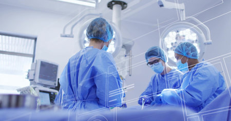 Operating surgical team performing operation in surgical suite, with lights and monitor overlays....