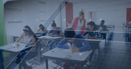 Supervising teacher in red observing students writing papers at classroom desks with calculator. Education, learning, classroom, teamwork, concentration, modern, academicの写真素材