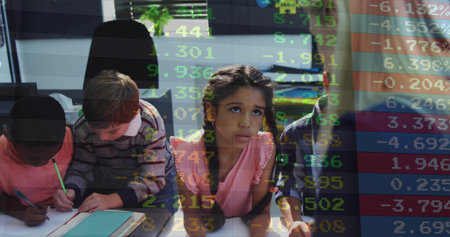Students writing in notebooks at desks in a classroom. The scene includes pencils, a potted plant, and a bright, collaborative atmosphere. Education, teamwork, innovation, learning, youthful, collaborative, modern.の写真素材