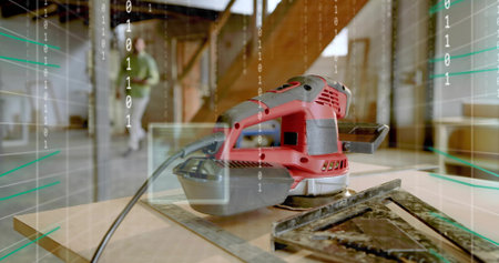 Carpenter in green shirt walking between beams in attic workshop, with sander. Craftsmanship, renovation, industrial, modern, workspace, innovation, constructionの写真素材