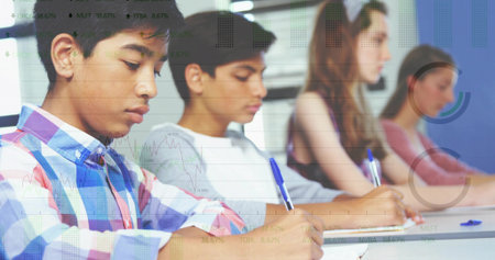 Writing four teenage students focusing on paper at classroom desk, with blue pens. Students, education, learning, study, organization, academic, classroomの写真素材
