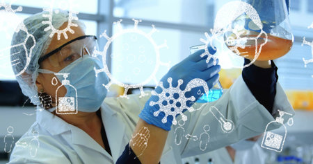 Examining scientist wearing lab coat analyzing orange lab flask at bench. Scientist, laboratory, research, chemical, experimentation, innovation, scientificの写真素材