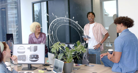 Presenting man holding tablet and speaking in modern conference room, with VR monitors....