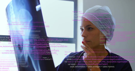 Observing bone scan, Asian woman wearing hair cap, dark scrubs interpreting overlaid code, in lab. Medical technology, healthcare, diagnostics, research, innovation, professional, clinicalの写真素材