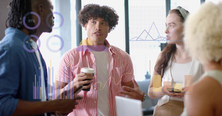 Four professionals discussing digital chart overlays in modern office meeting area, with laptop....