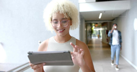Tapping tablet woman in tank top and glasses while man sipping coffee cup in glass-railed corridor....