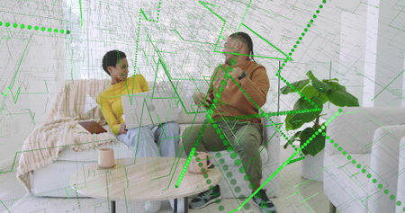 Collaborating friends using smartphone, laptop in living room with coffee table and digital overlay....