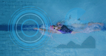 Gliding swimmer wearing one-piece swimsuit, swim cap and goggles in lap pool, showing lane divider....