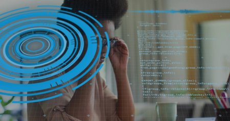 Adjusting eyeglasses woman typing on laptop at office, with holographic interface and floating code. Technology, innovation, digital, workspace, modern, professional, focusの写真素材