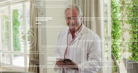 Standing senior medical professional holding tablet in sunlit sunroom, with digital overlays. Healthcare, technology, interior design, wellness, modern, senior, comfortの写真素材
