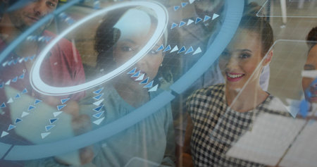 Collaborating five professionals using glass touchscreen panel in office with data visualizations....