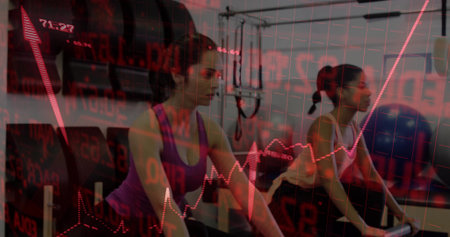 Pedaling friends wearing workout gear riding exercise bikes in gym. Fitness, endurance, collaboration, motivation, strength, activewear, wellnessの写真素材