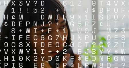 Asian woman speaking into smartphone in office with desk, plant, blinds, code overlay, copy space. Technology, communication, workspace, productivity, modern, innovation, digitalの写真素材