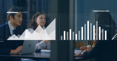 Reviewing professionals examining digital charts in conference room, with laptop papers pens. Corporate, teamwork, analytics, modern, collaboration, data visualization, professionalの写真素材