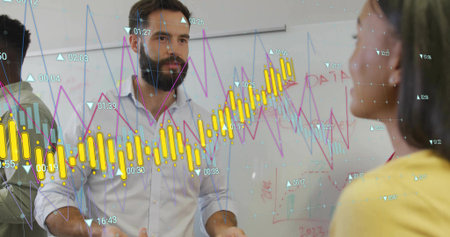 Colleagues in business attire analyzing data on office whiteboard, with digital bar and line graphs....
