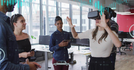 Demonstrating woman wearing VR headset gesturing forward in office, with smartphone and tablet....