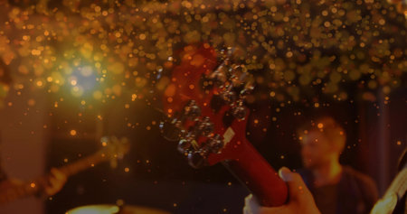 Focusing red electric guitar headstock showing silver tuning pegs on stage, golden bokeh. Guitar, musicians, stage, performance, lighting, entertainment, soundの写真素材