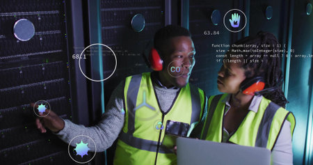 Two technicians wearing vests diagnosing racks in data center aisle, with laptop and data icons....